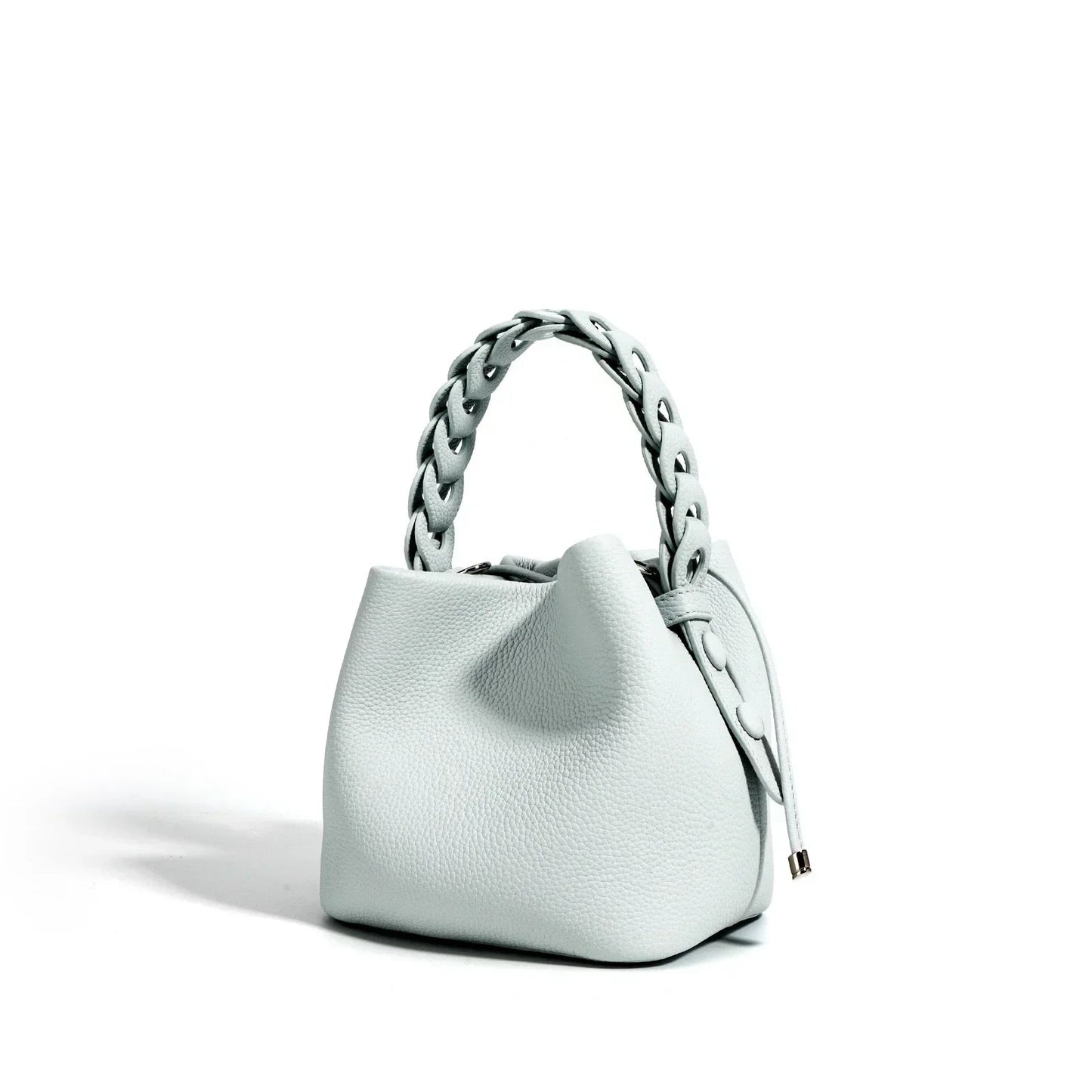 Light gray textured leather handbag with braided handle on white background