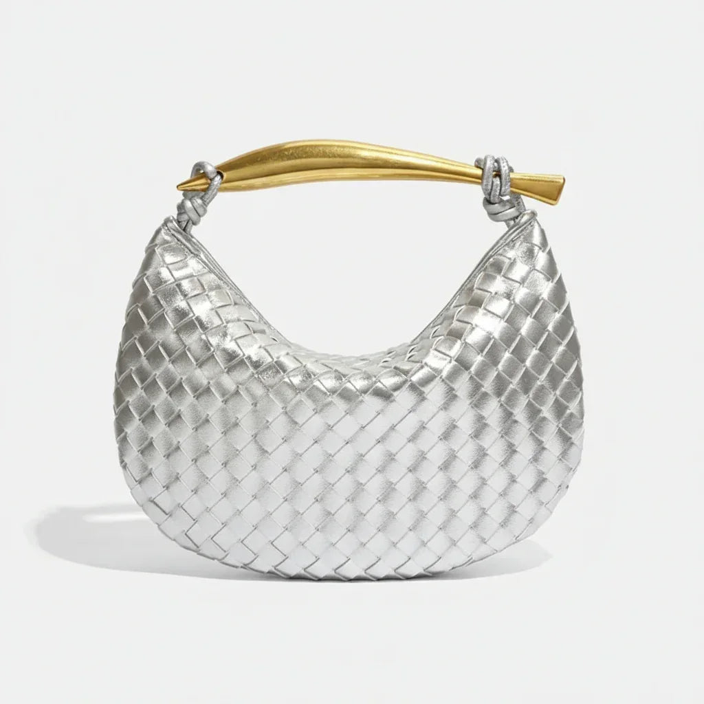 Silver woven hobo bag with gold curved handle on white background