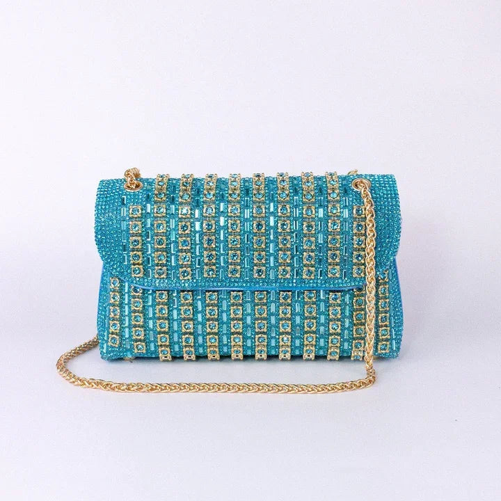 Turquoise beaded clutch bag with gold chain strap and crystal embellishments on white background