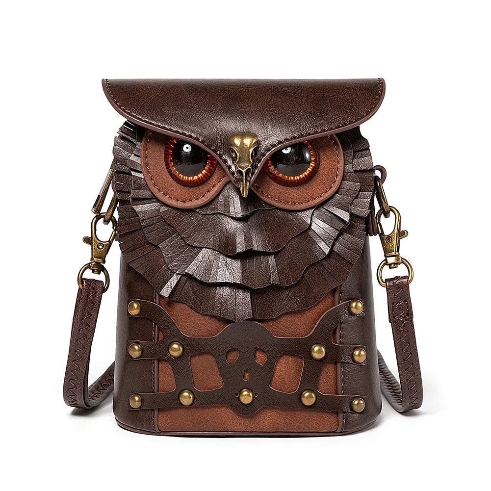 Brown leather crossbody bag shaped like an owl with large eyes and feather details