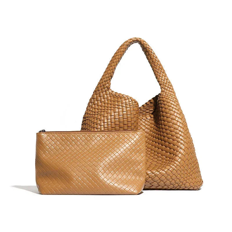 Tan woven leather tote bag and matching clutch on white background