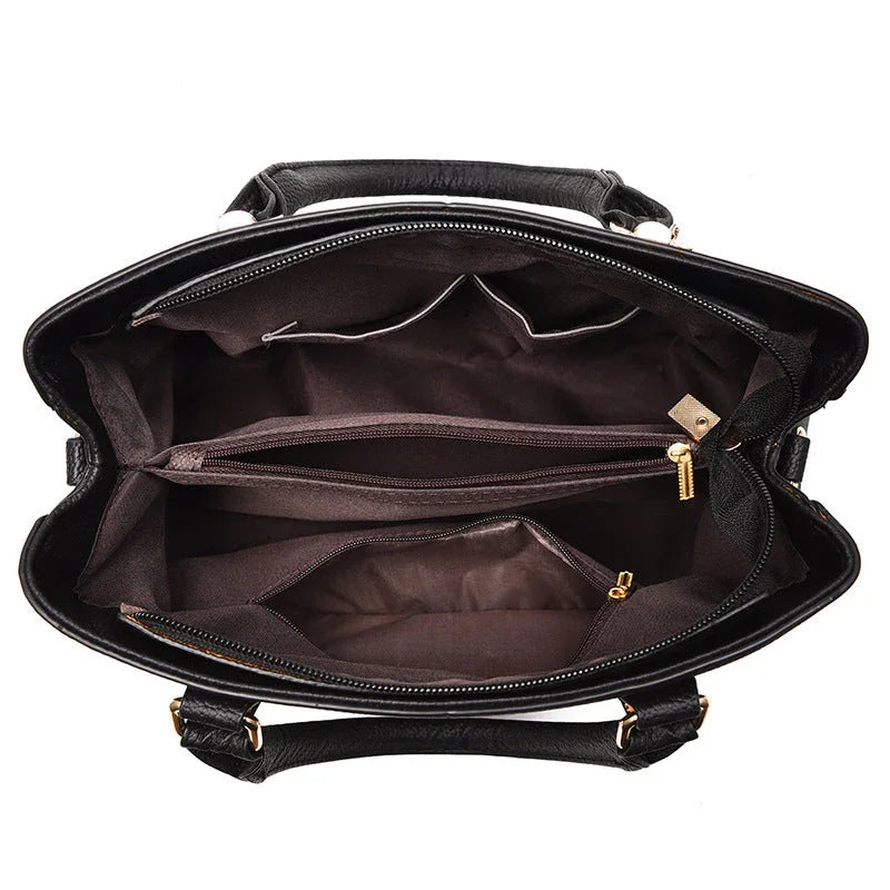 Top view of black leather handbag interior with multiple zippered compartments and pockets