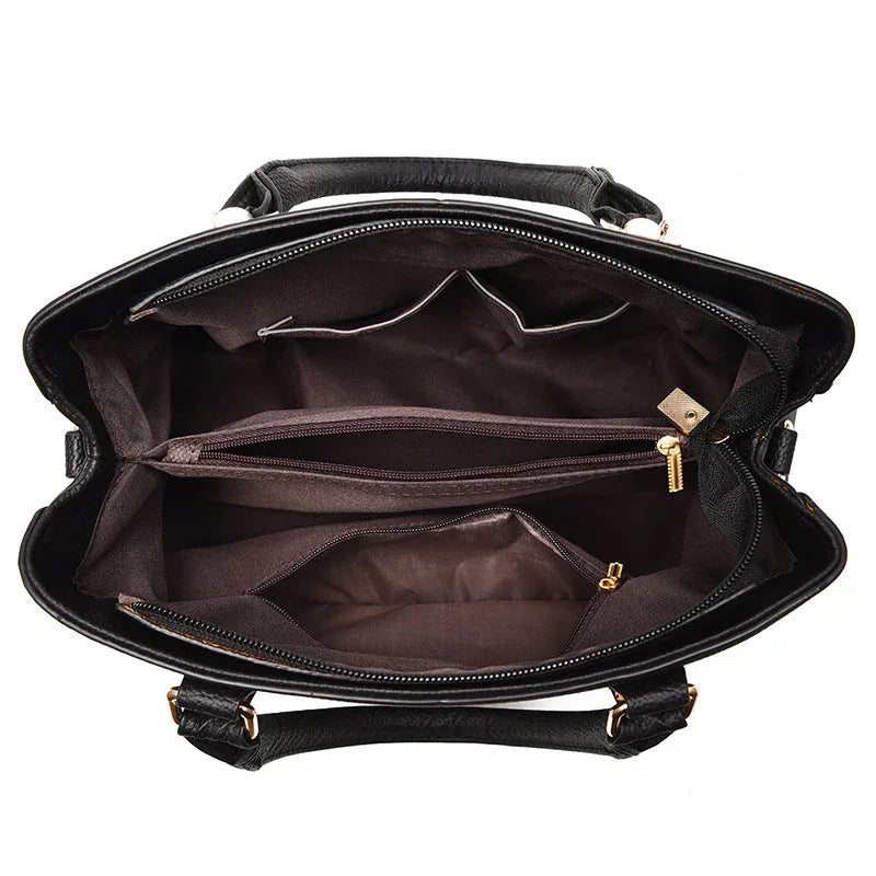 Top view of black leather handbag interior with multiple zippered compartments and pockets