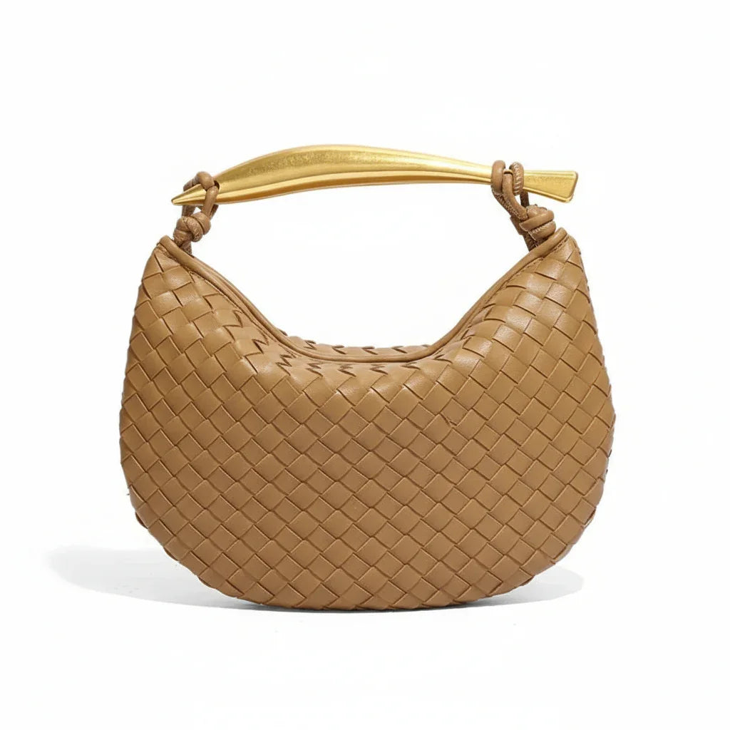 Brown woven leather handbag with gold handle on white background
