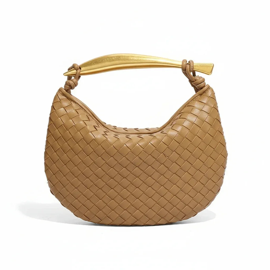 Brown woven leather handbag with gold handle on white background