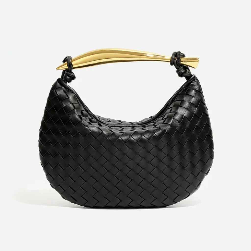 Black woven leather handbag with gold curved handle on white background