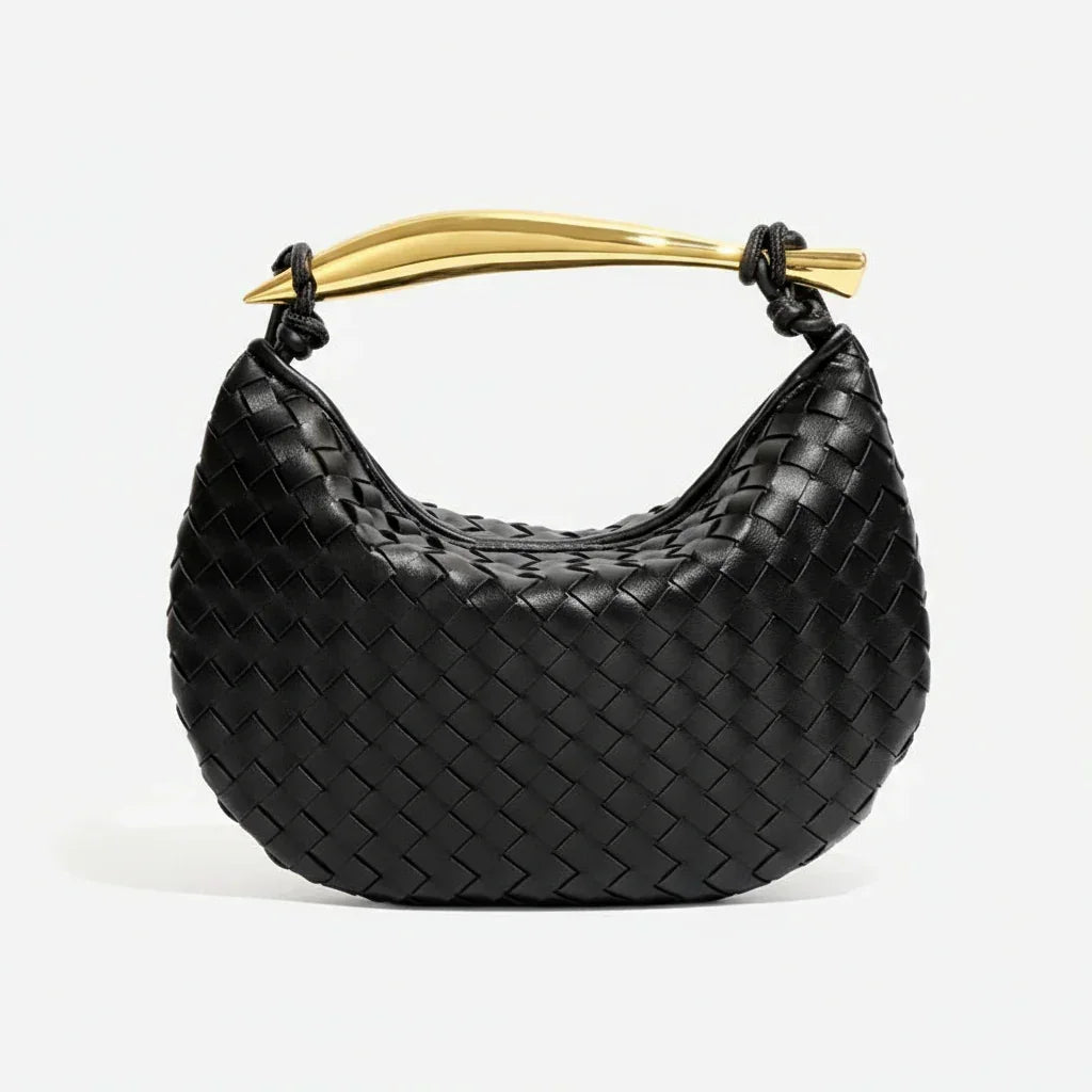 Black woven leather handbag with gold curved handle on white background