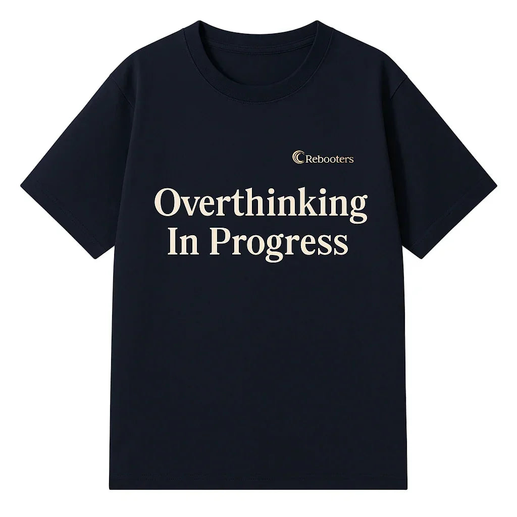 Black t-shirt with 'Overthinking In Progress' text and Rebooters logo on a white background