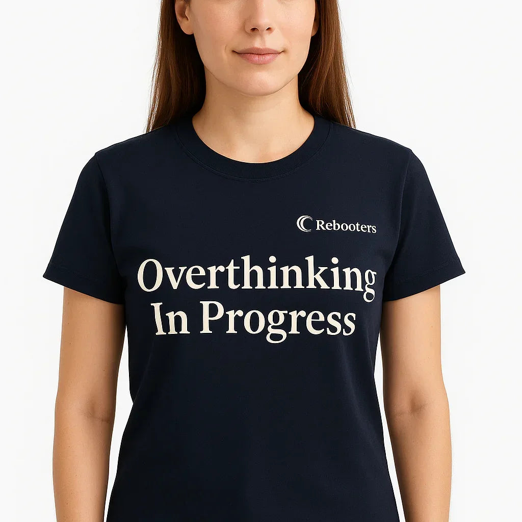 Person wearing a black t-shirt with 'Overthinking In Progress' text and Rebooters logo.