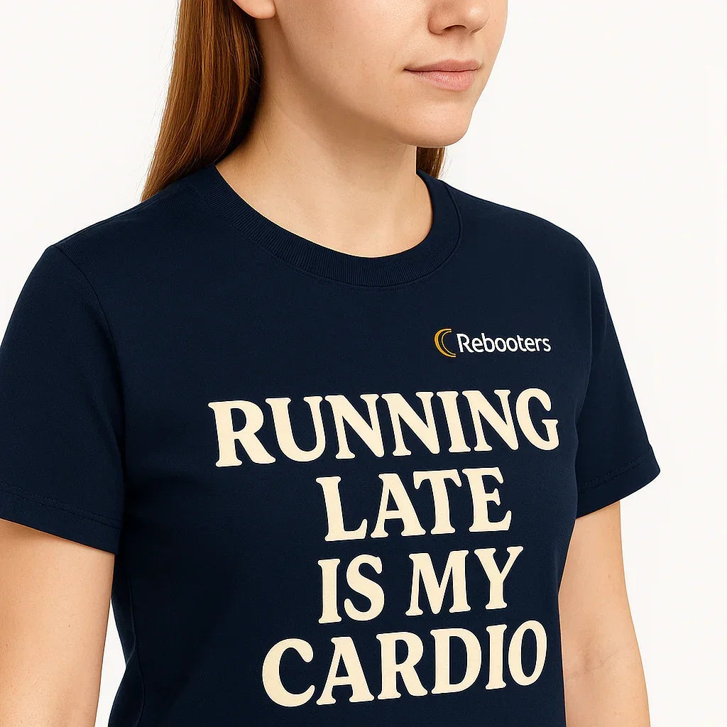 Person wearing a navy blue t-shirt with 'Running Late is My Cardio' text and Rebooters logo.