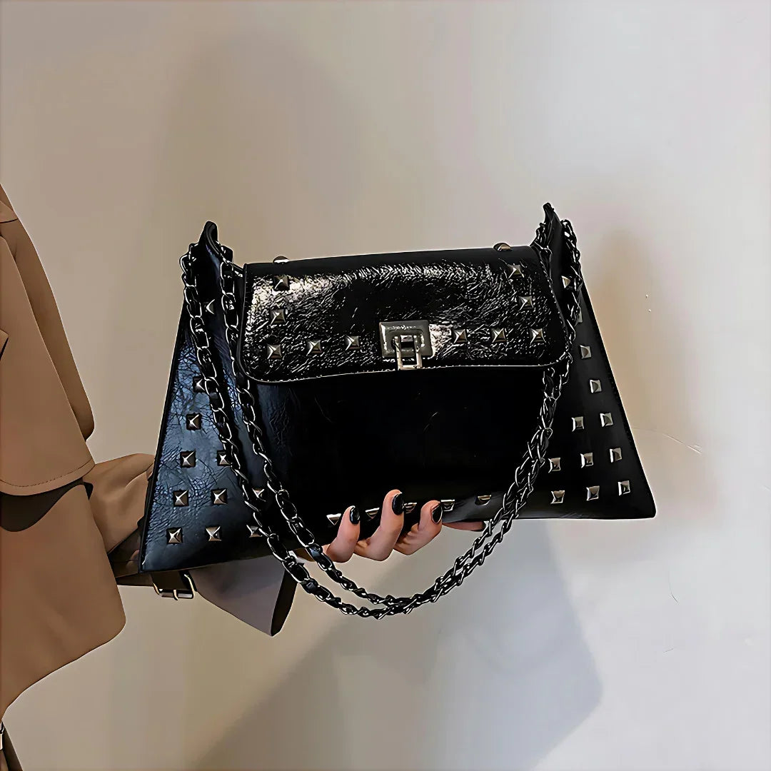Black studded leather handbag with chain strap and silver lock clasp