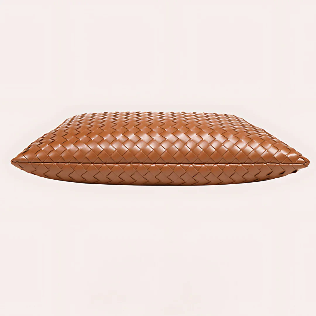 Brown woven leather clutch bag on light background, luxury accessory