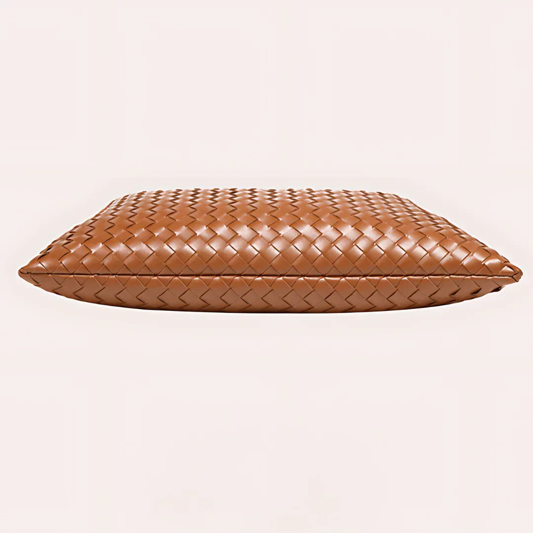 Brown woven leather clutch bag on light background, luxury accessory