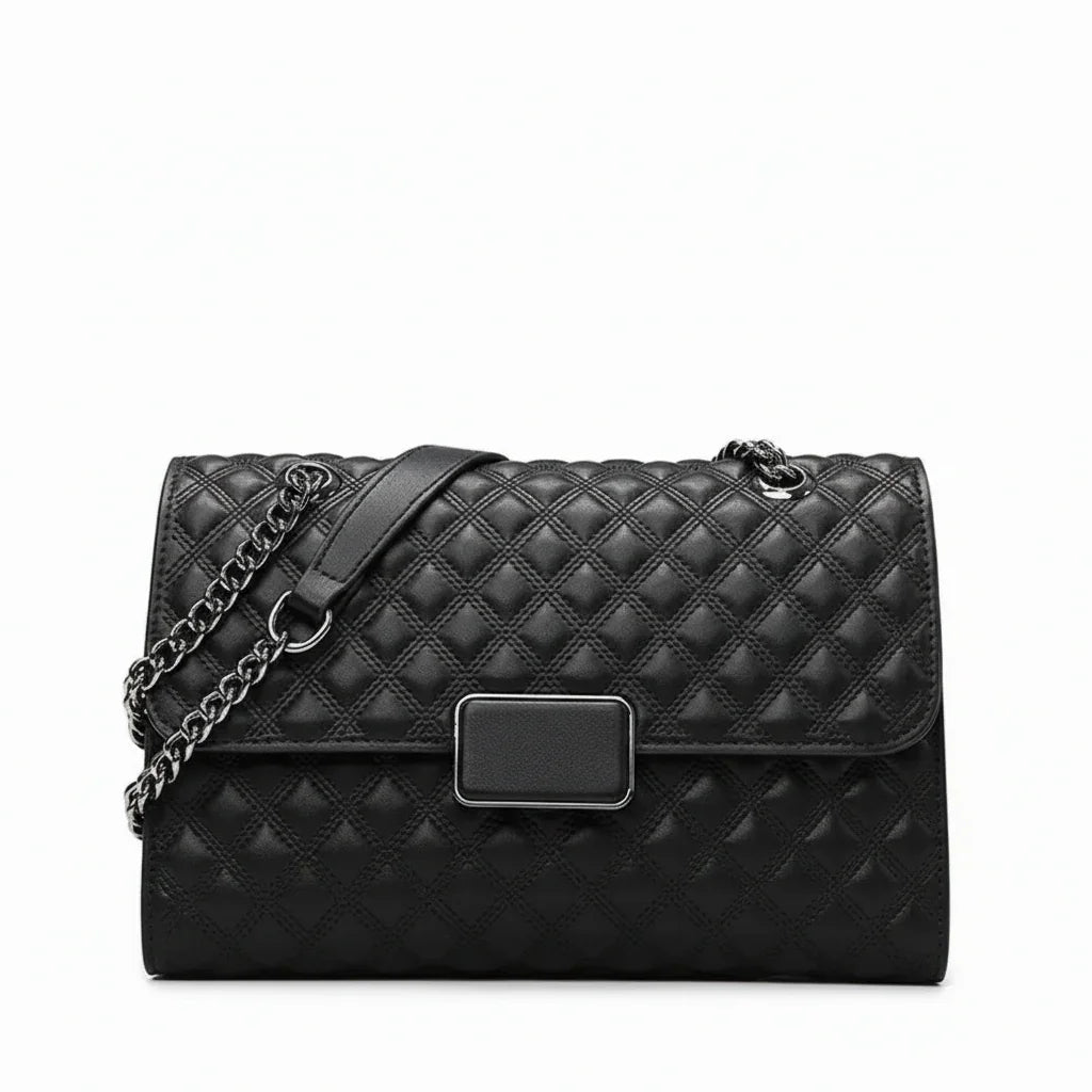 Black quilted leather handbag with chain strap and rectangular metal clasp on white background
