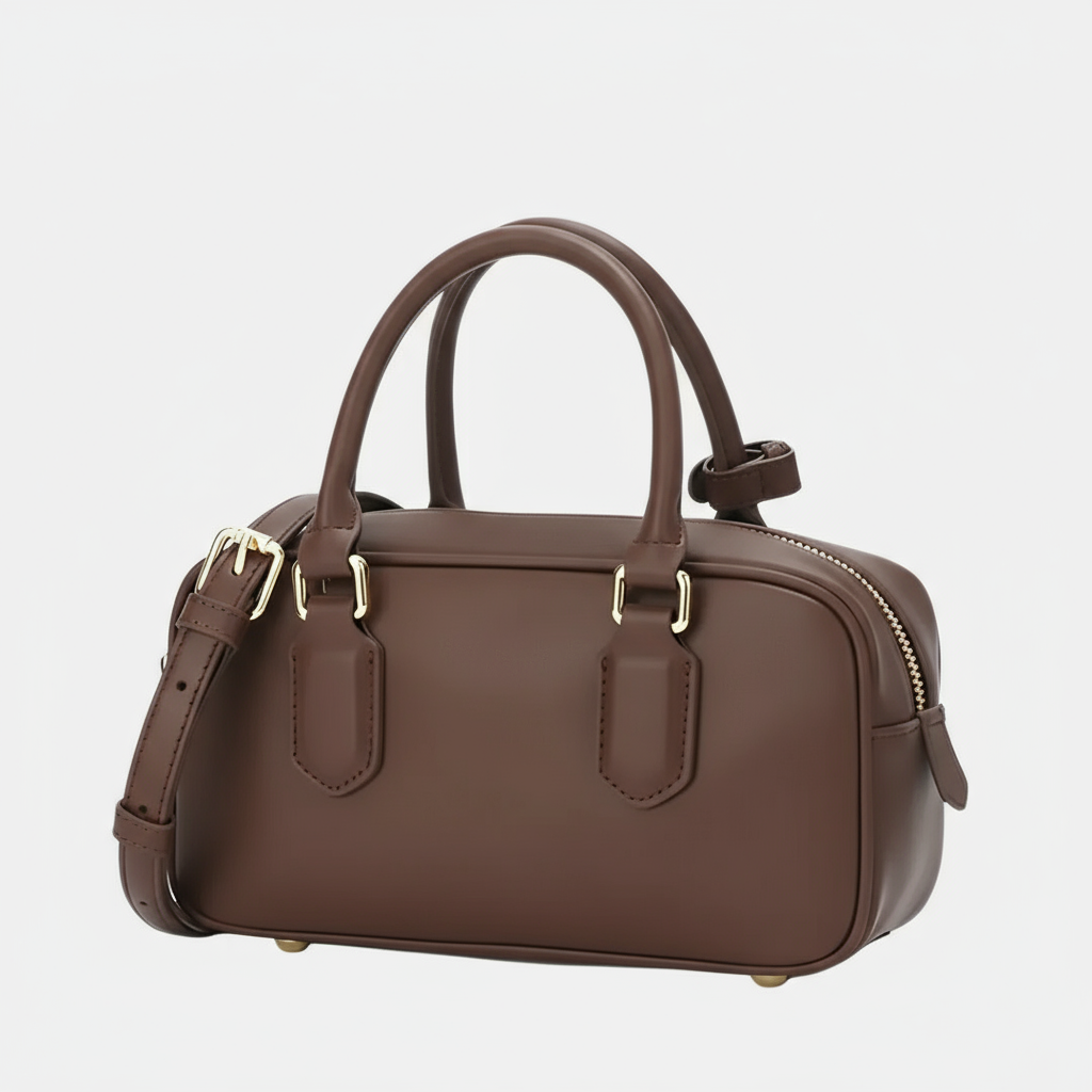 Brown leather handbag with gold hardware, top handles, detachable strap on white background