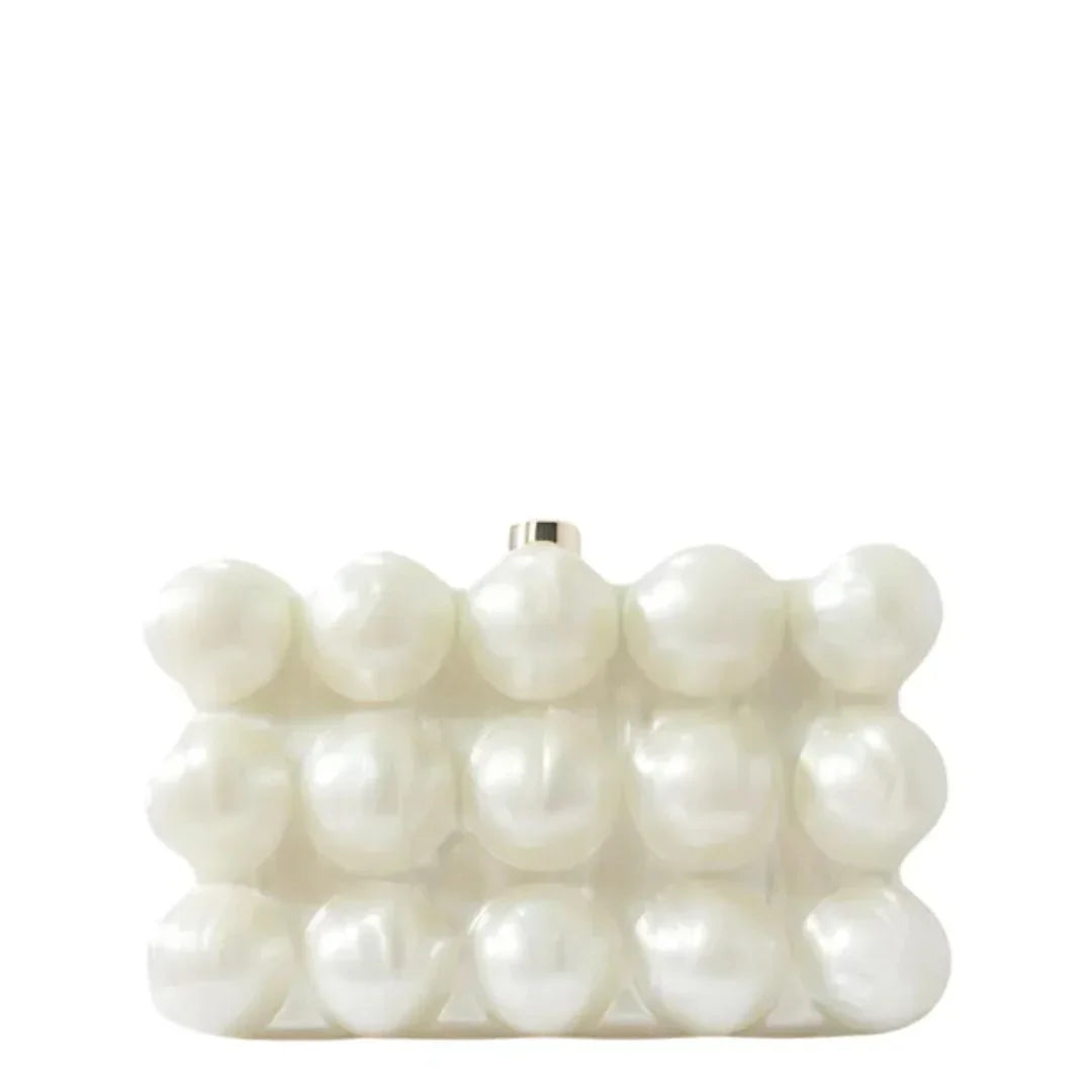 White pearl beaded clutch handbag with geometric design on a plain background