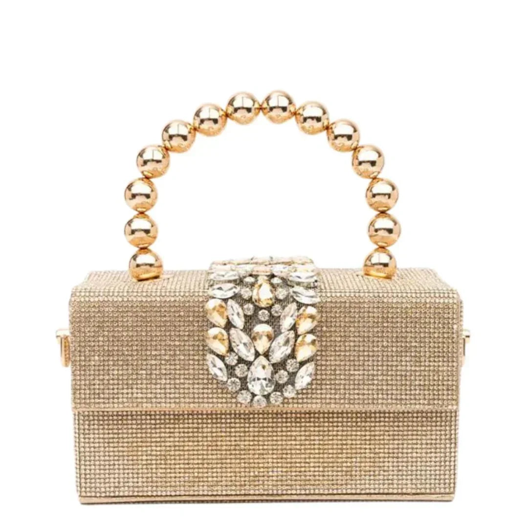 Gold beaded clutch purse with jeweled clasp and round metallic handle on white background
