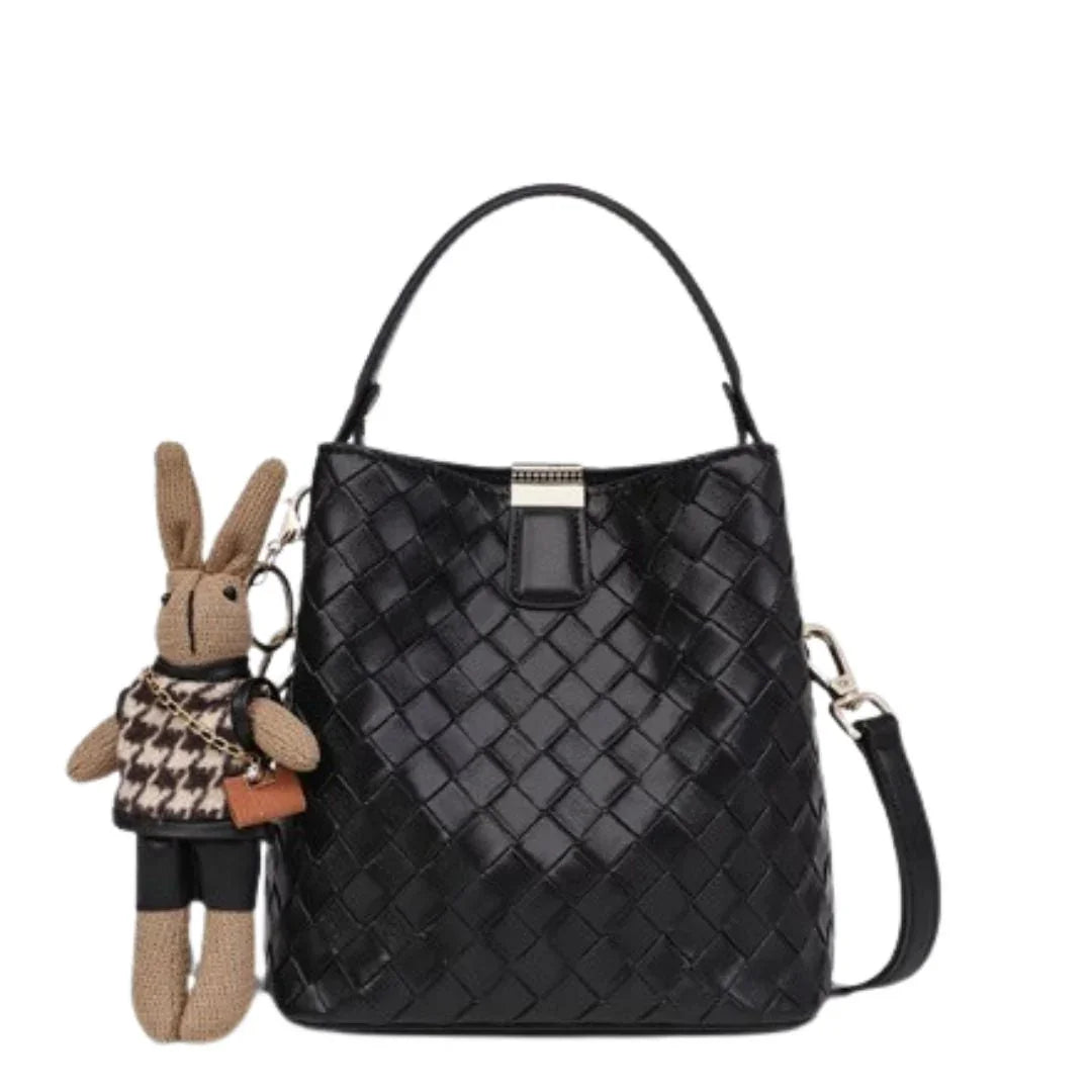 Black woven leather handbag with top handle and cute bunny keychain accessory