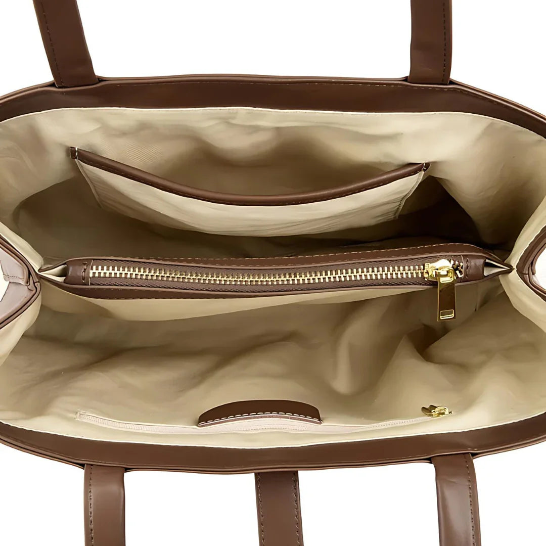 Brown leather tote bag interior with beige lining, zippered pocket, and open compartments