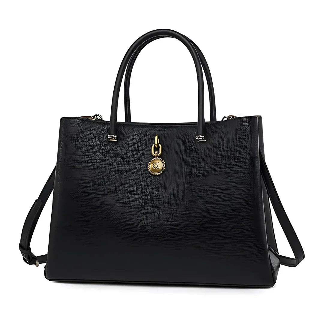 Black leather tote bag with gold medallion charm and dual top handles