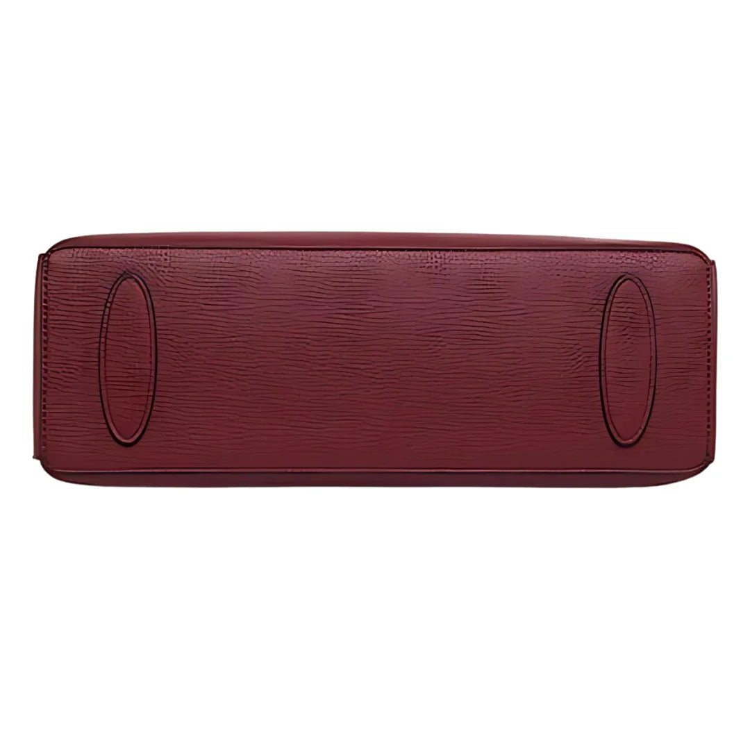 Bottom view of textured burgundy leather handbag with two oval stitched accents