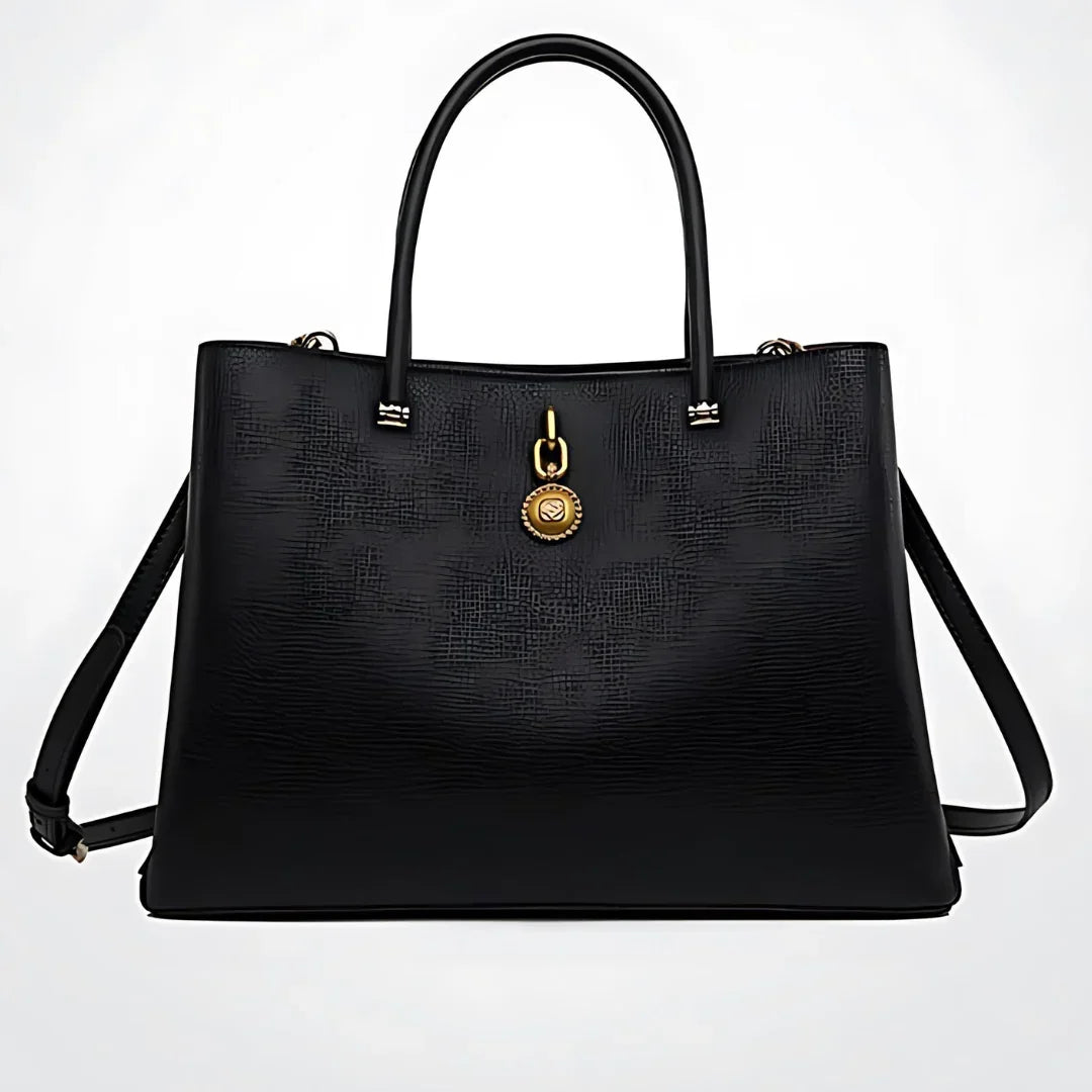 Black textured leather handbag with gold medallion accent and double handles