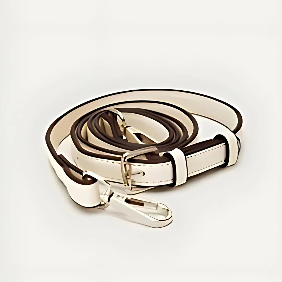 White leather bag strap with silver clasp on a plain background