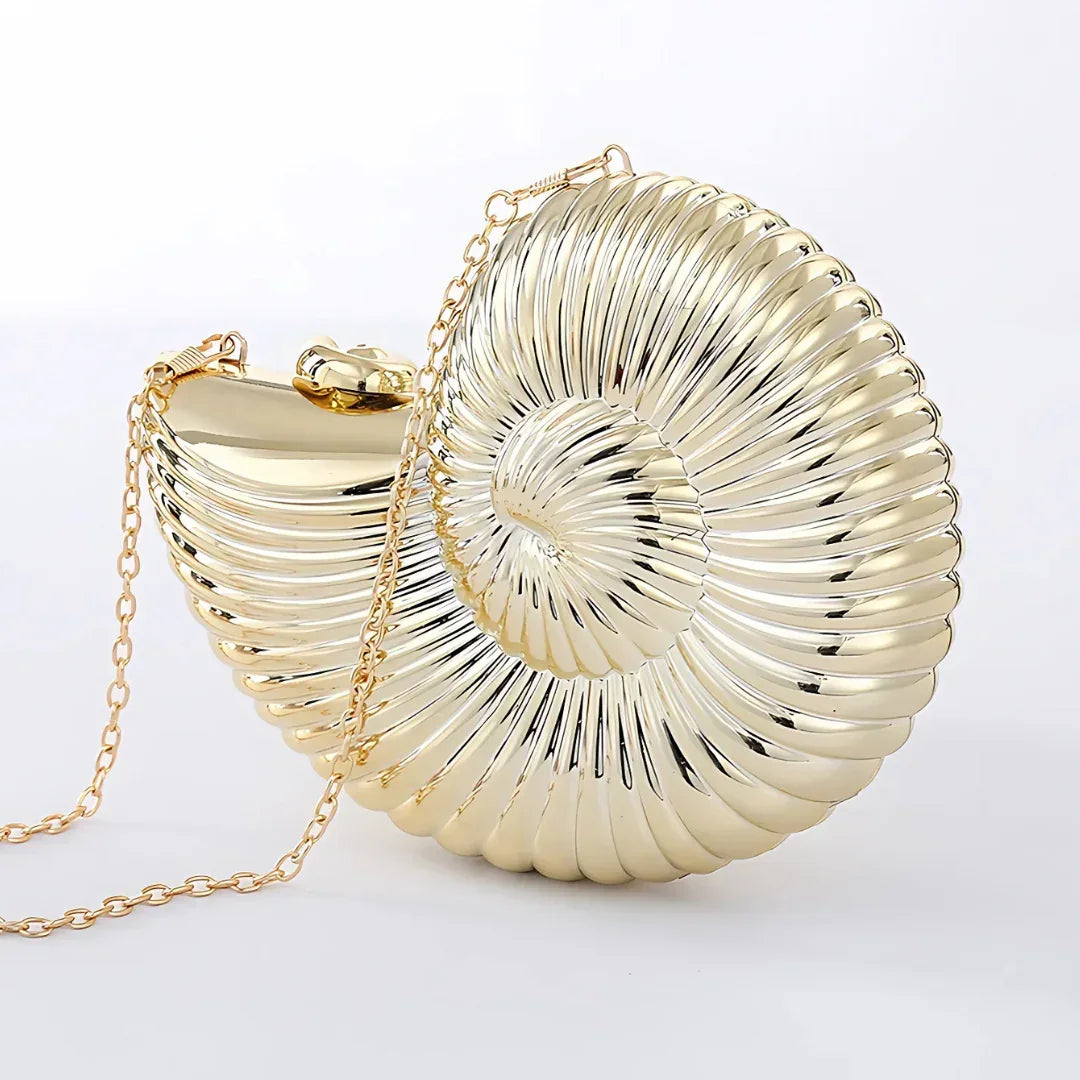 Gold metallic shell-shaped clutch bag with chain strap on white background