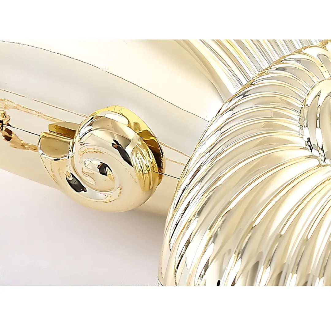 Close-up of a shiny gold decorative vase with textured spiral detail