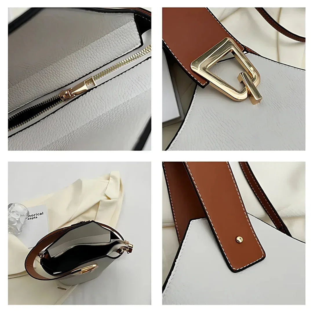 Close-up of white and brown leather tote bag with gold hardware details and zipper