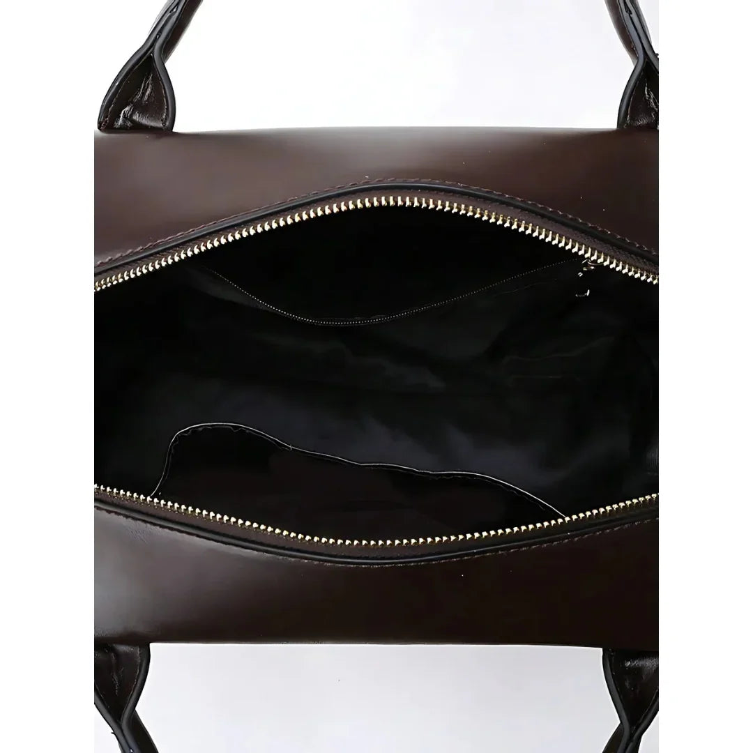 Open brown leather handbag with zipper, showing spacious black interior and handles