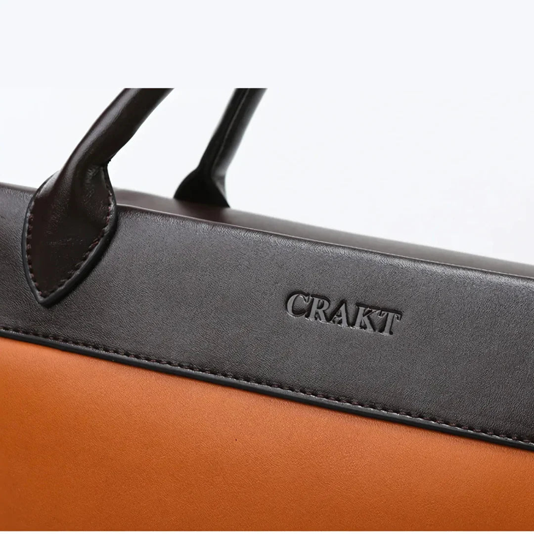 CRAKT brown leather handbag with black handles, close-up detail view