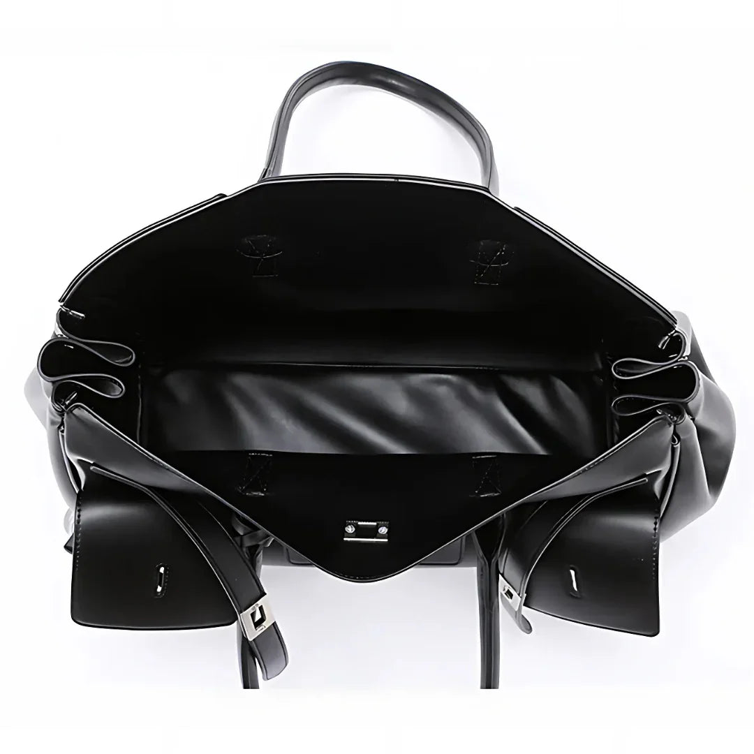 Open black leather tote bag with spacious interior and silver buckle detail