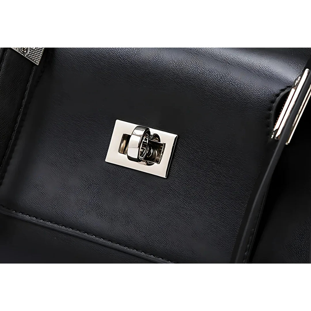 Black leather bag with shiny silver turn-lock clasp close-up