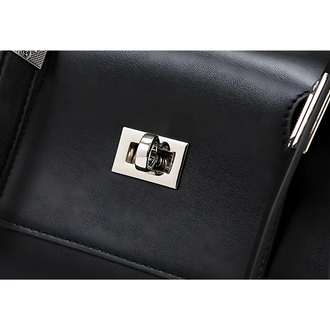 Black leather bag with shiny silver turn-lock clasp close-up