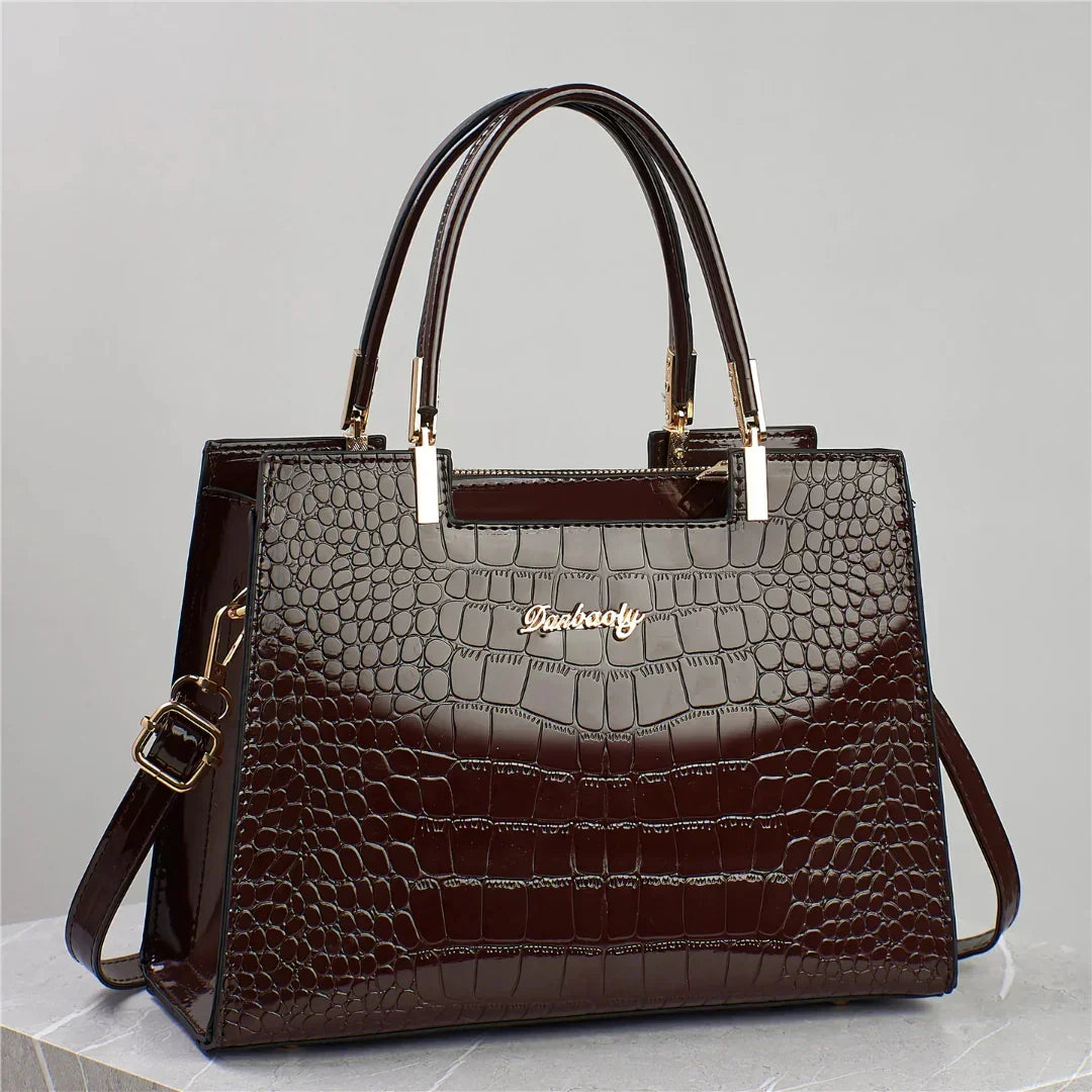 Dark brown crocodile pattern leather handbag with gold hardware and double handles