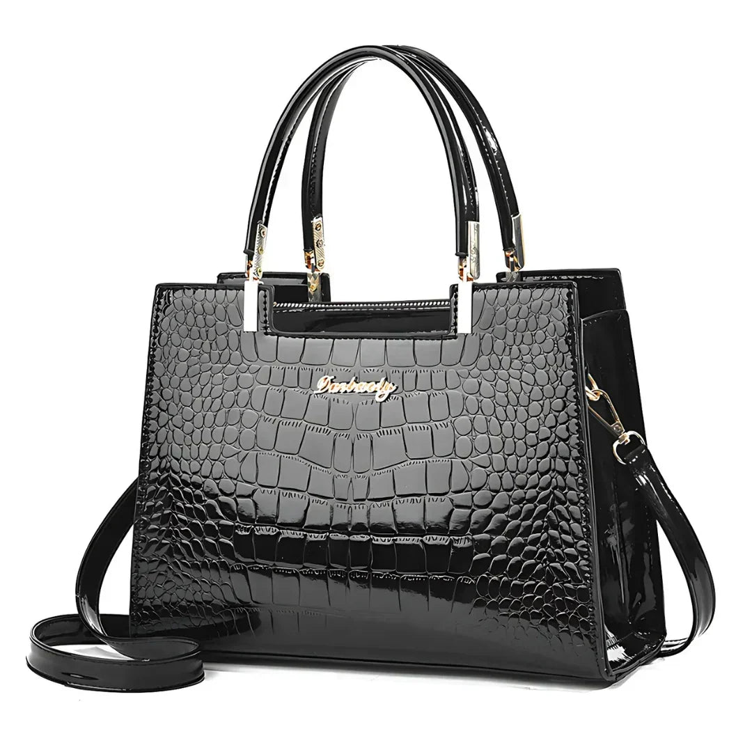 Glossy black crocodile pattern handbag with gold accents and top handles