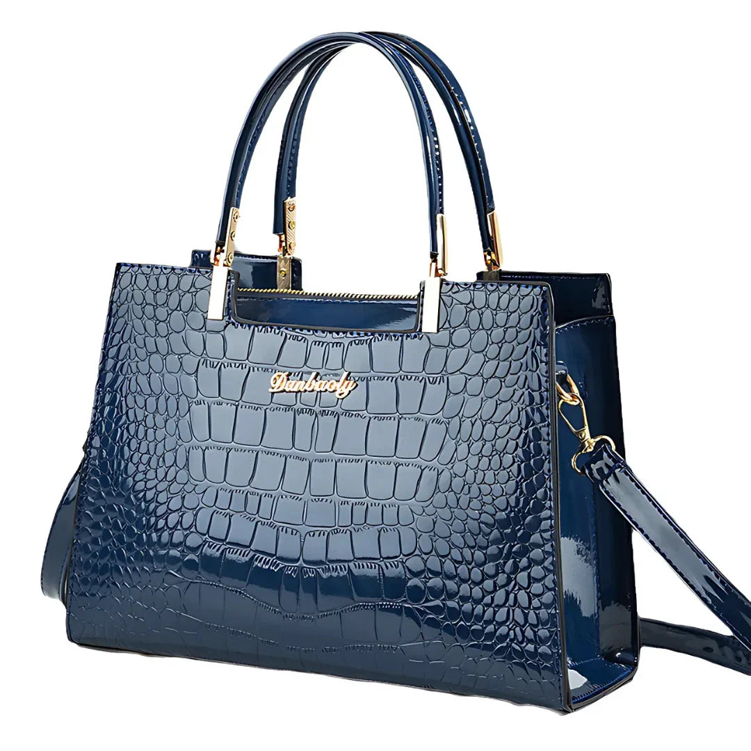 Glossy blue crocodile pattern handbag with gold hardware and top handles