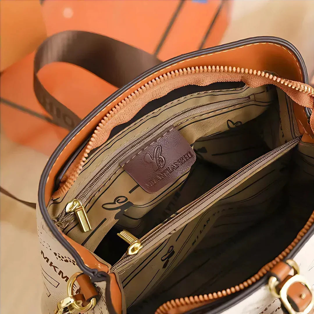 Interior of beige designer handbag with gold zipper, multiple pockets, branded lining