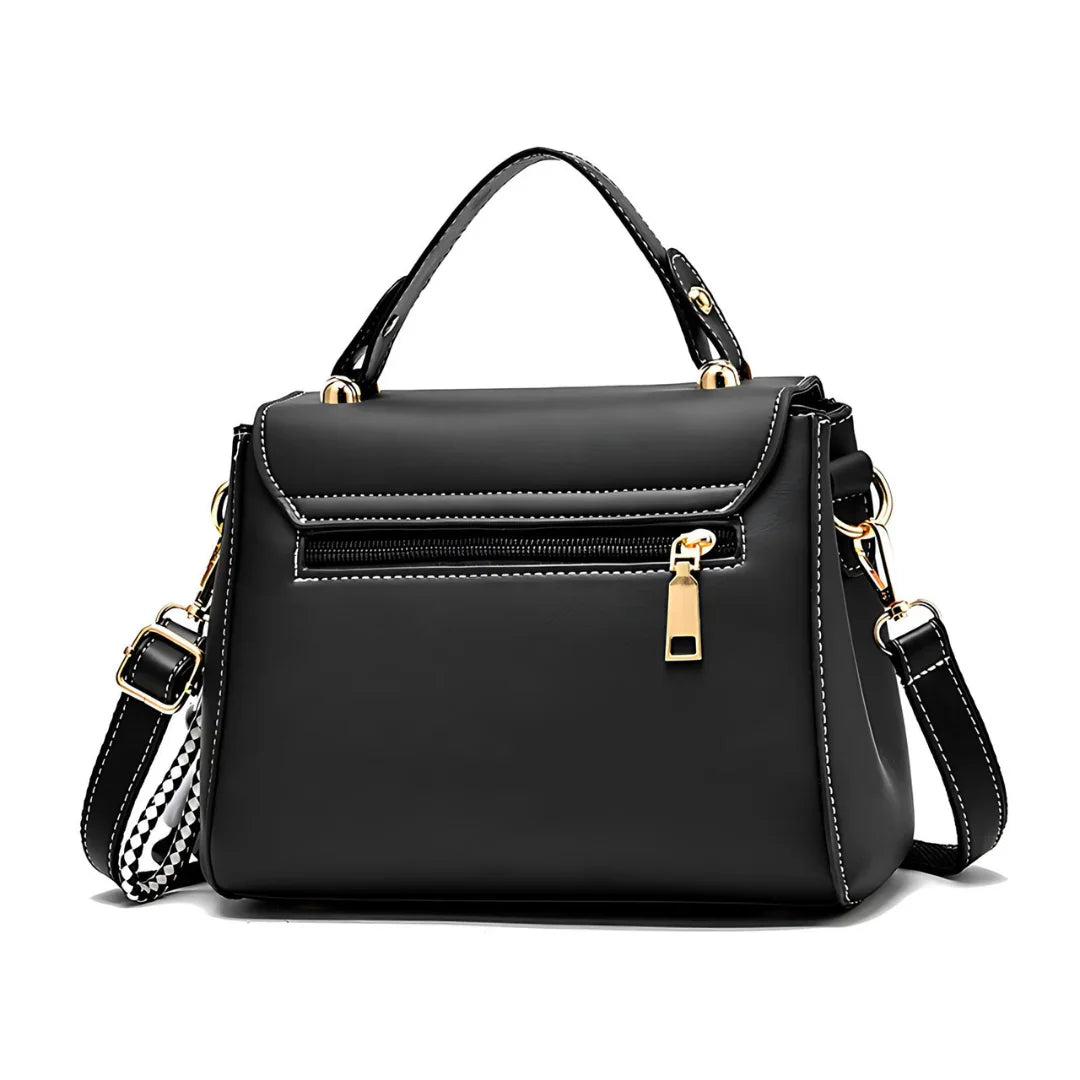 Black leather handbag with gold zipper, handle, adjustable strap, and white stitching