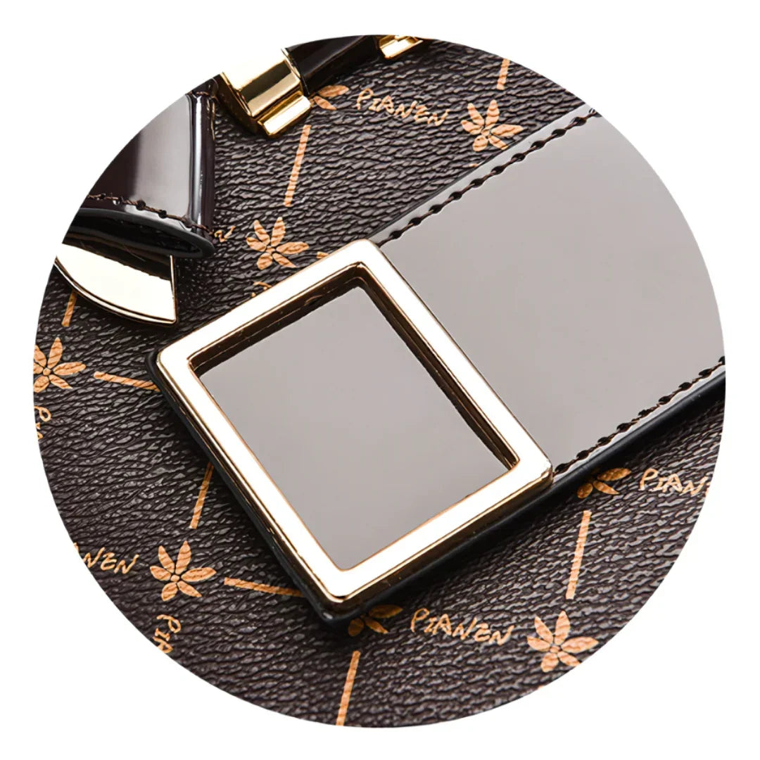 Close-up of brown leather handbag with gold buckle and floral pattern, PIANJEN logo