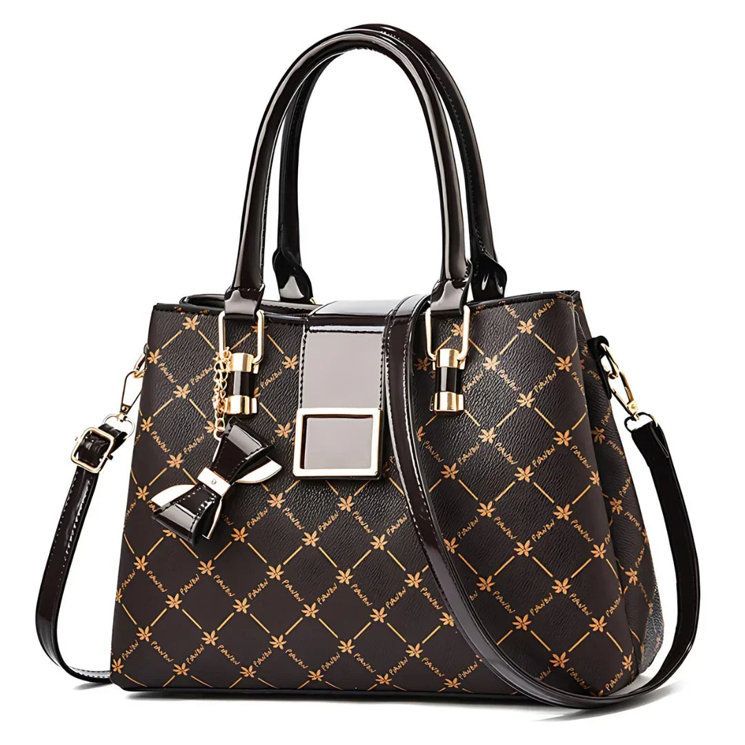 Elegant black and gold patterned handbag with top handles and bow charm