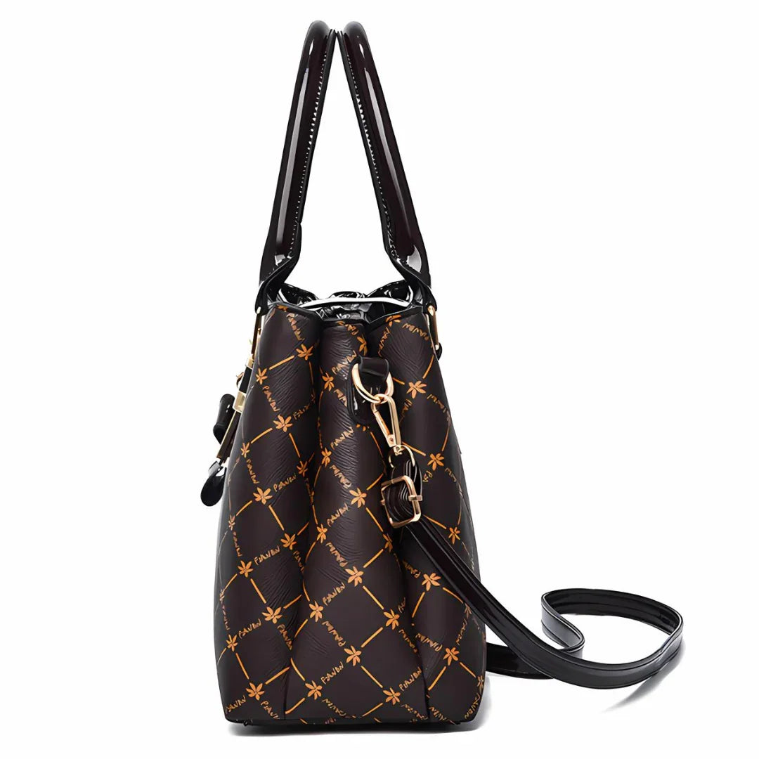 Brown designer tote bag with gold pattern, long handles, and gold-tone hardware