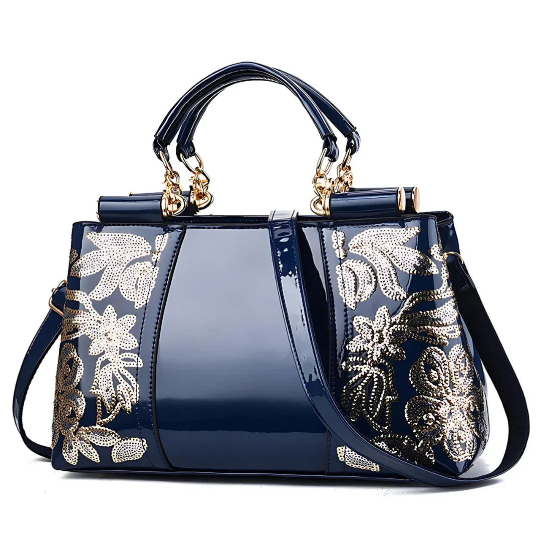 Shiny navy blue handbag with gold floral sequin accents and dual handles