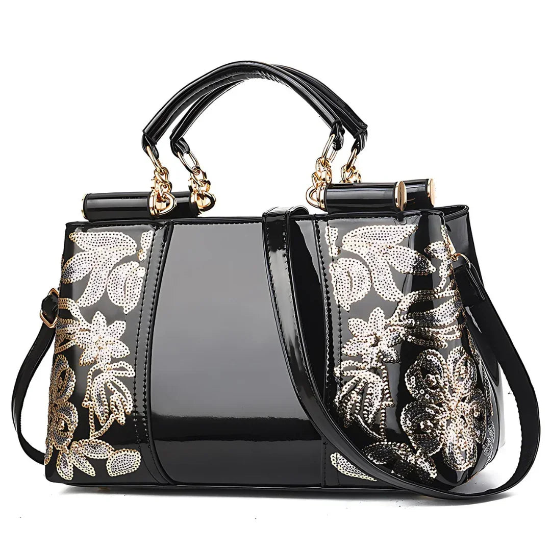 Glossy black handbag with gold floral sequin embroidery and dual handles