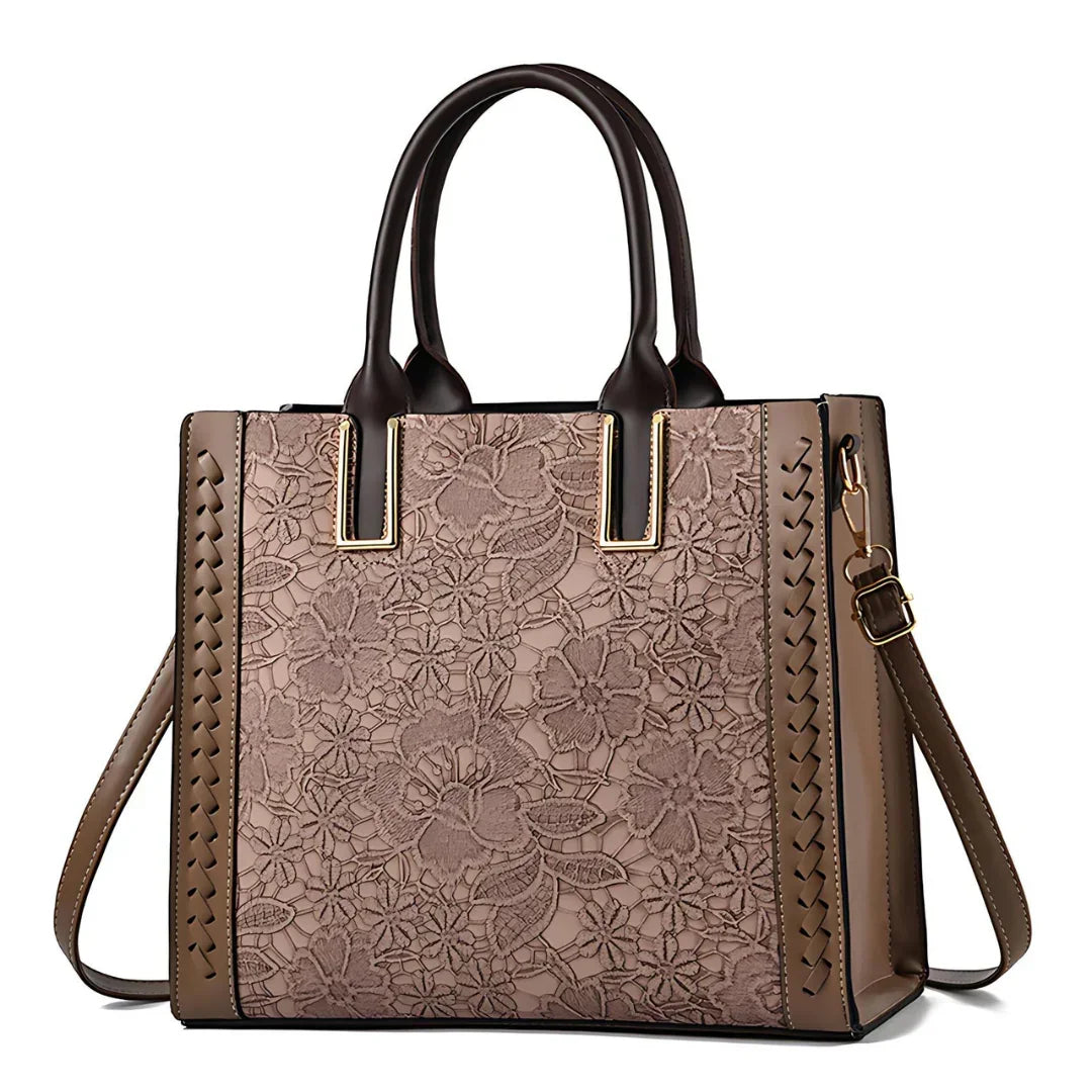 Brown floral handbag with lace pattern, leather accents, and gold hardware