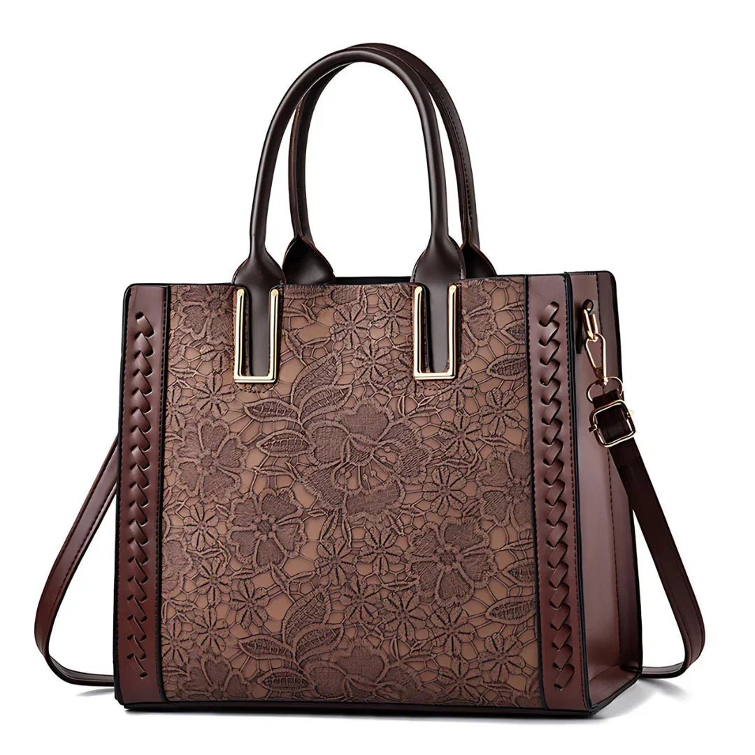Brown leather tote bag with floral lace pattern and double handles