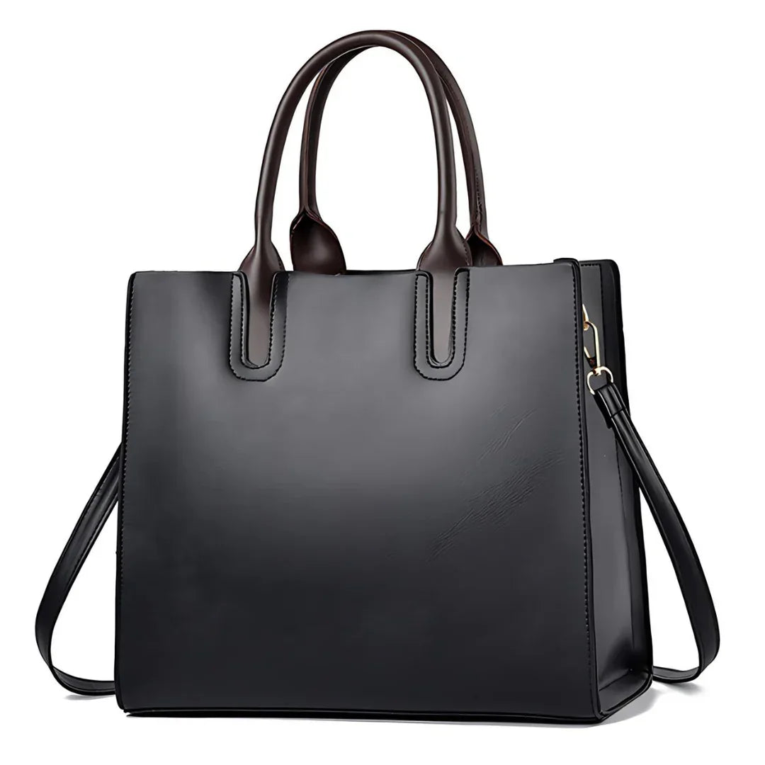 Black leather tote bag with dual brown handles and detachable shoulder strap