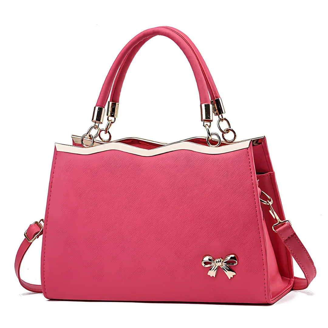 Elegant pink handbag with gold metal trim, top handles, and bow accent, women's fashion purse