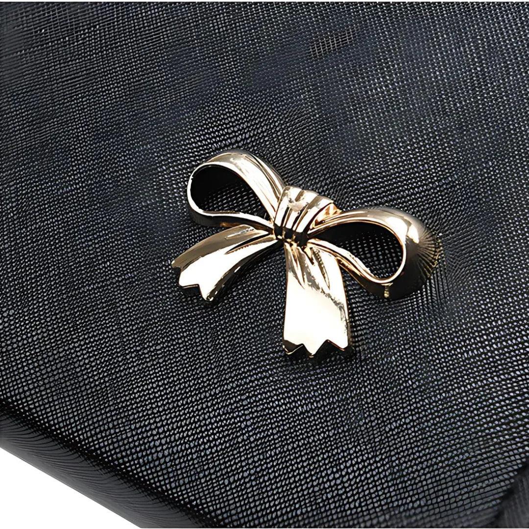 Black textured clutch with gold bow accent